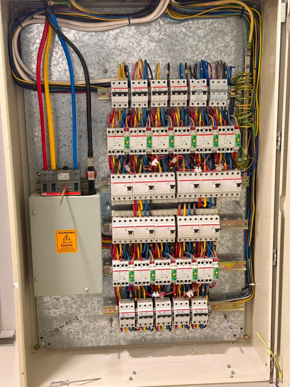 Colour-coded terminal rails beneath the breaker rows