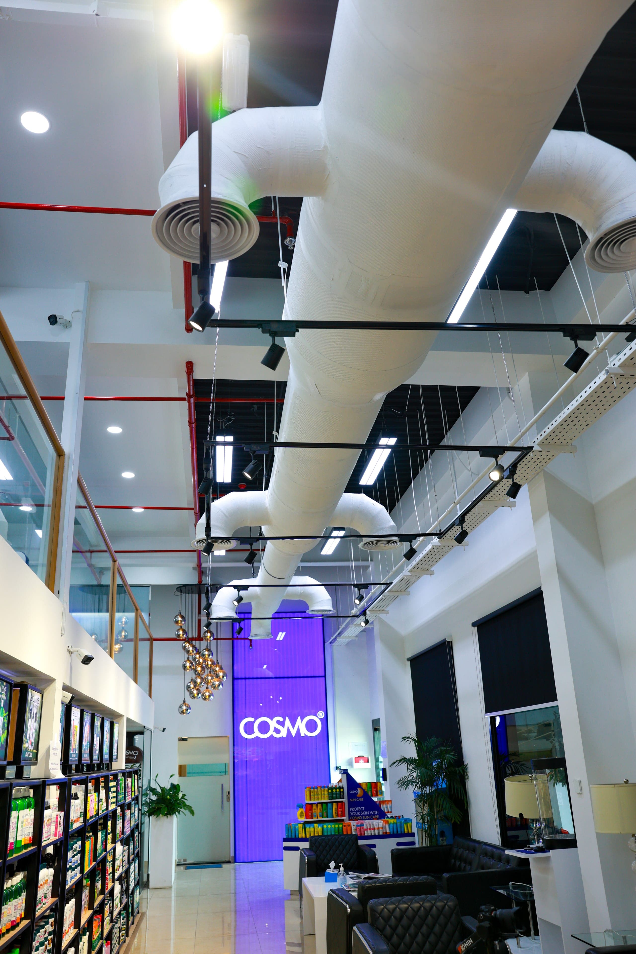 Ductwork and track lighting over the retail floor