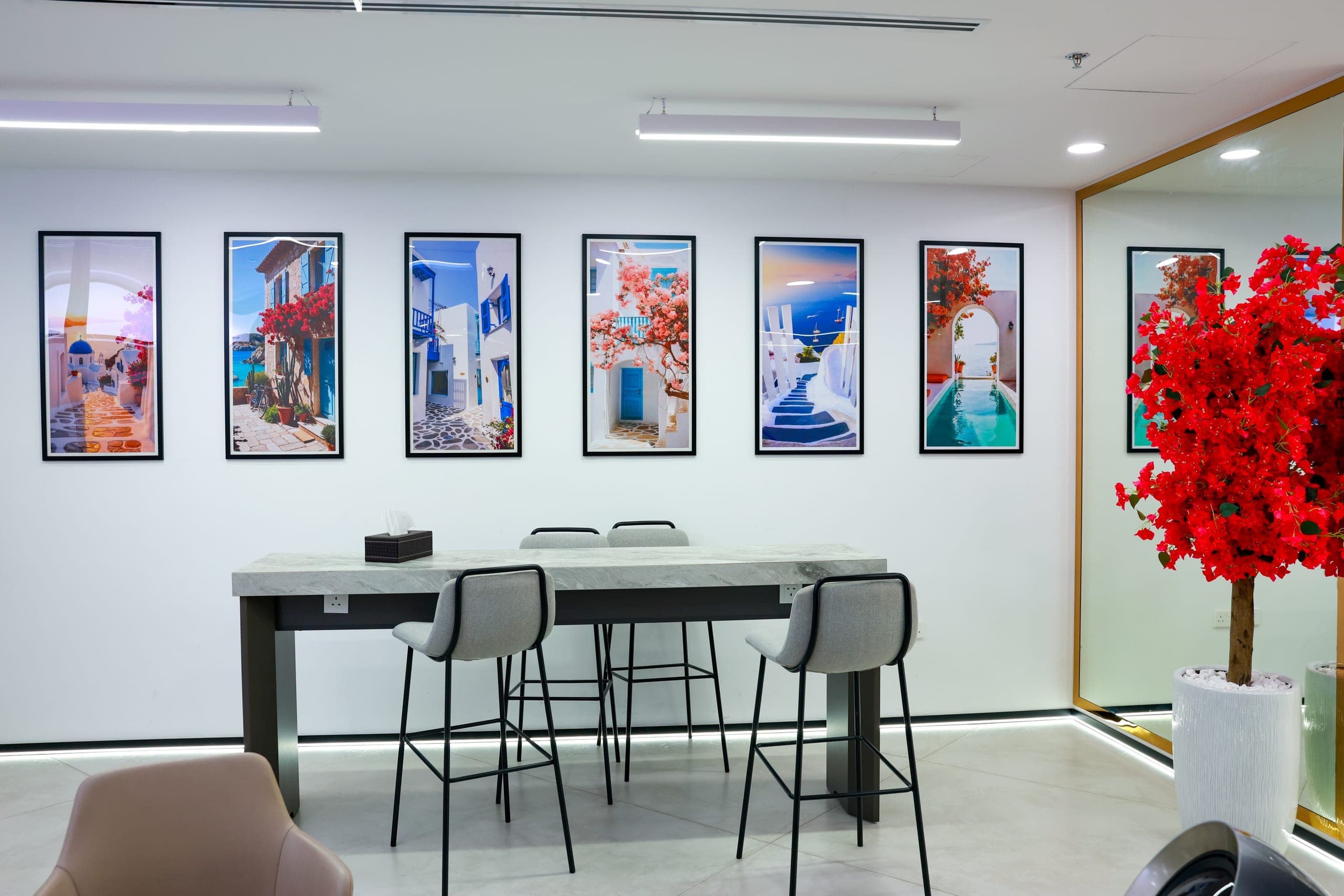 A breakout bar beneath a run of framed artwork