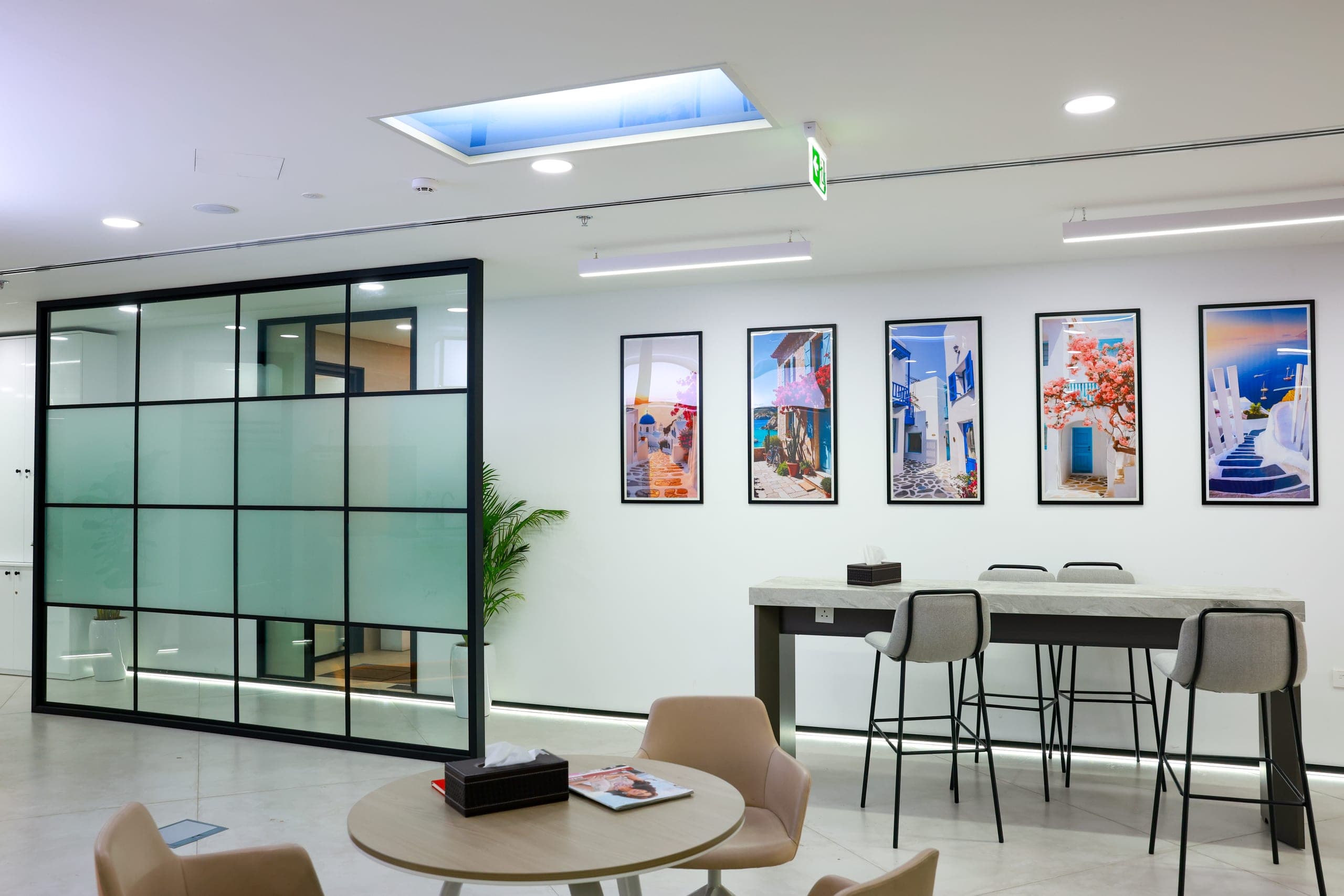 Framed artwork lining a glazed breakout space