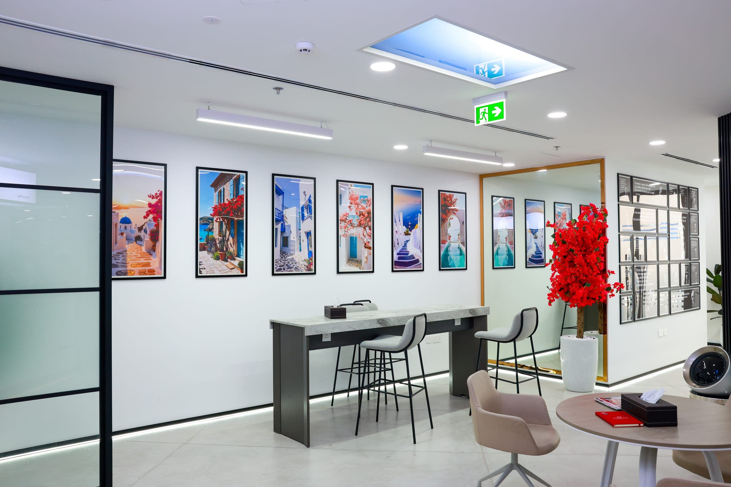 High stools and planting against a printed wall