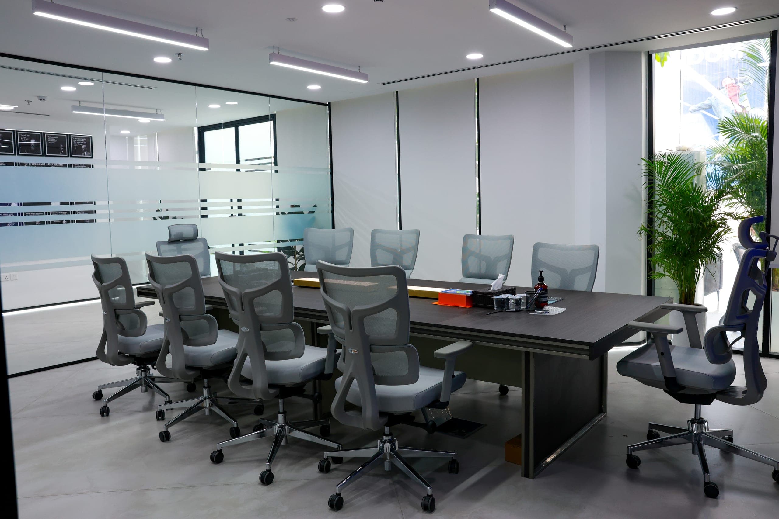 A boardroom glazed to the office floor beyond