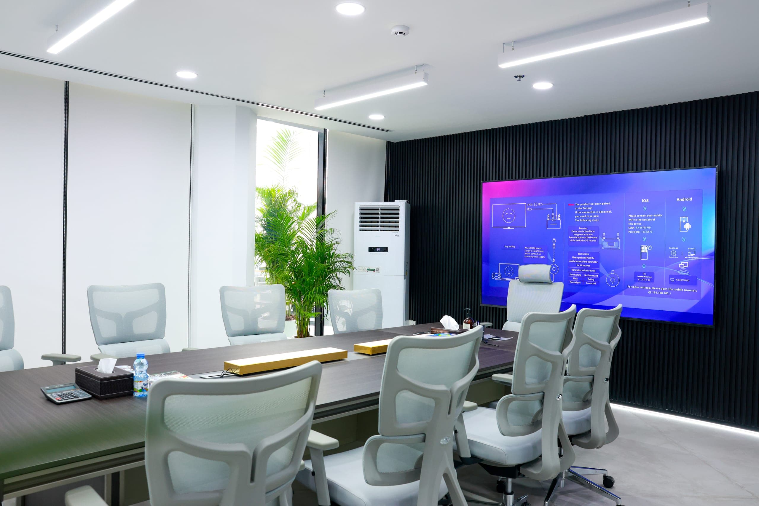 A meeting room with wall-mounted display and cooling