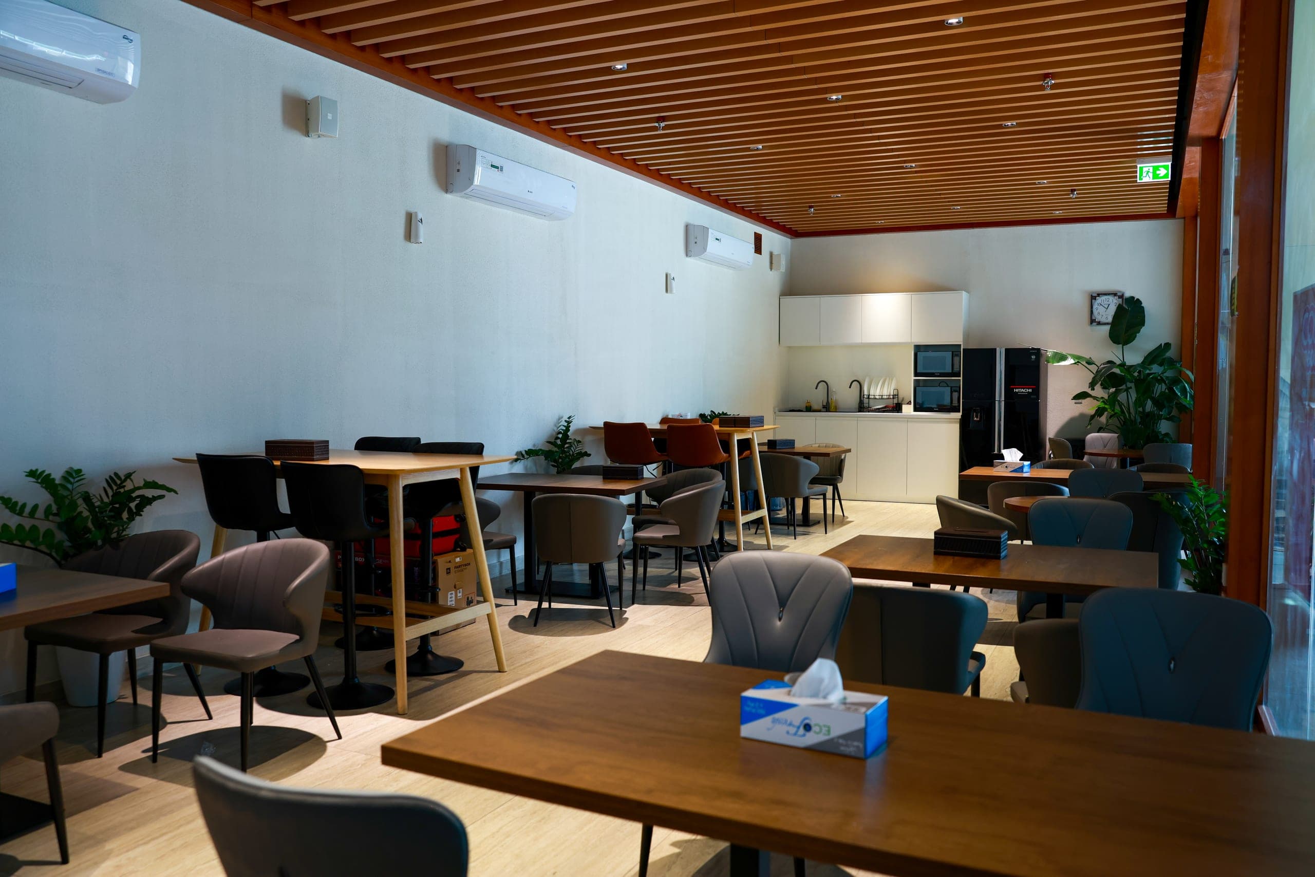 Dining seating beneath a timber-lined ceiling
