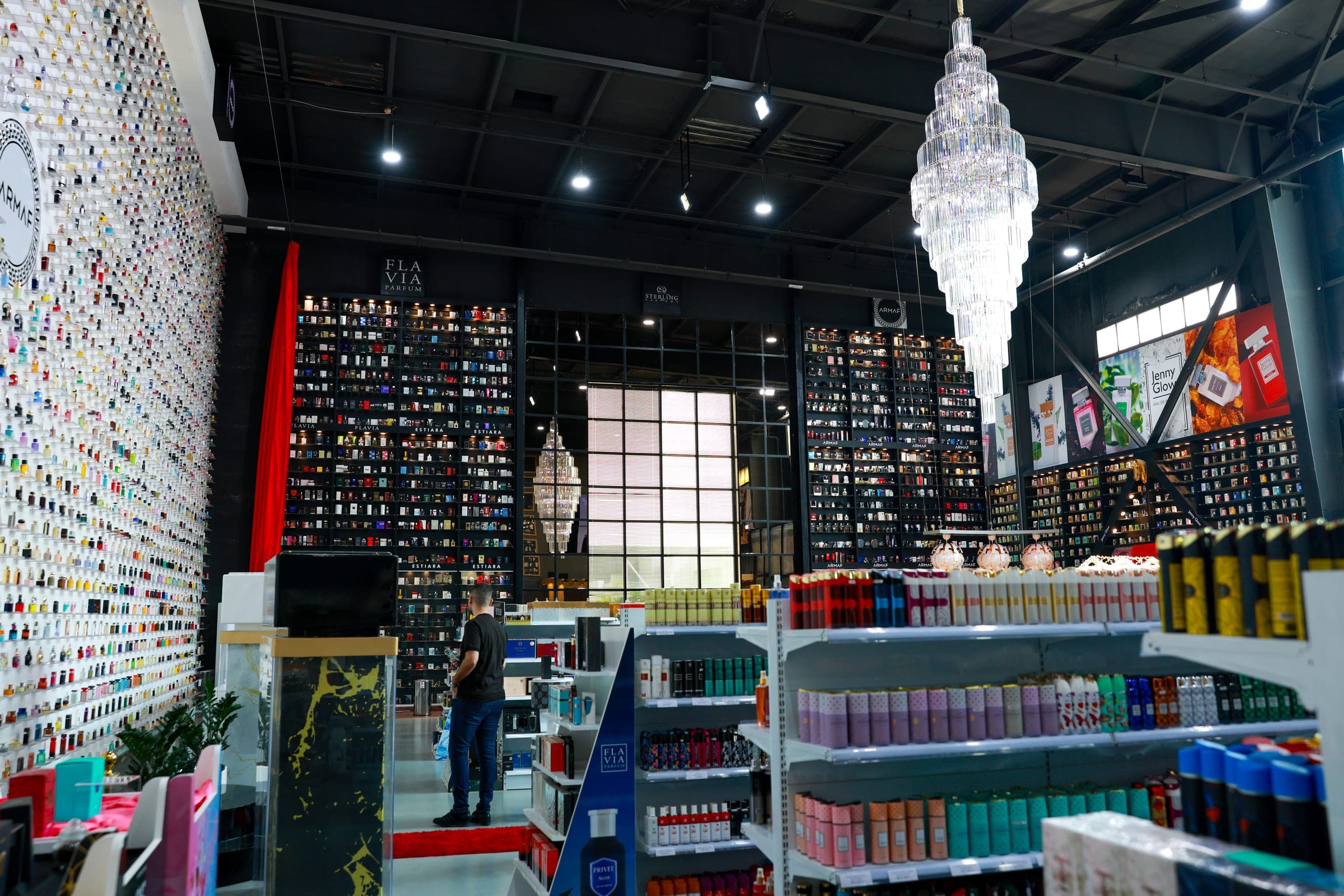 A cut-glass chandelier hung against black display shelving