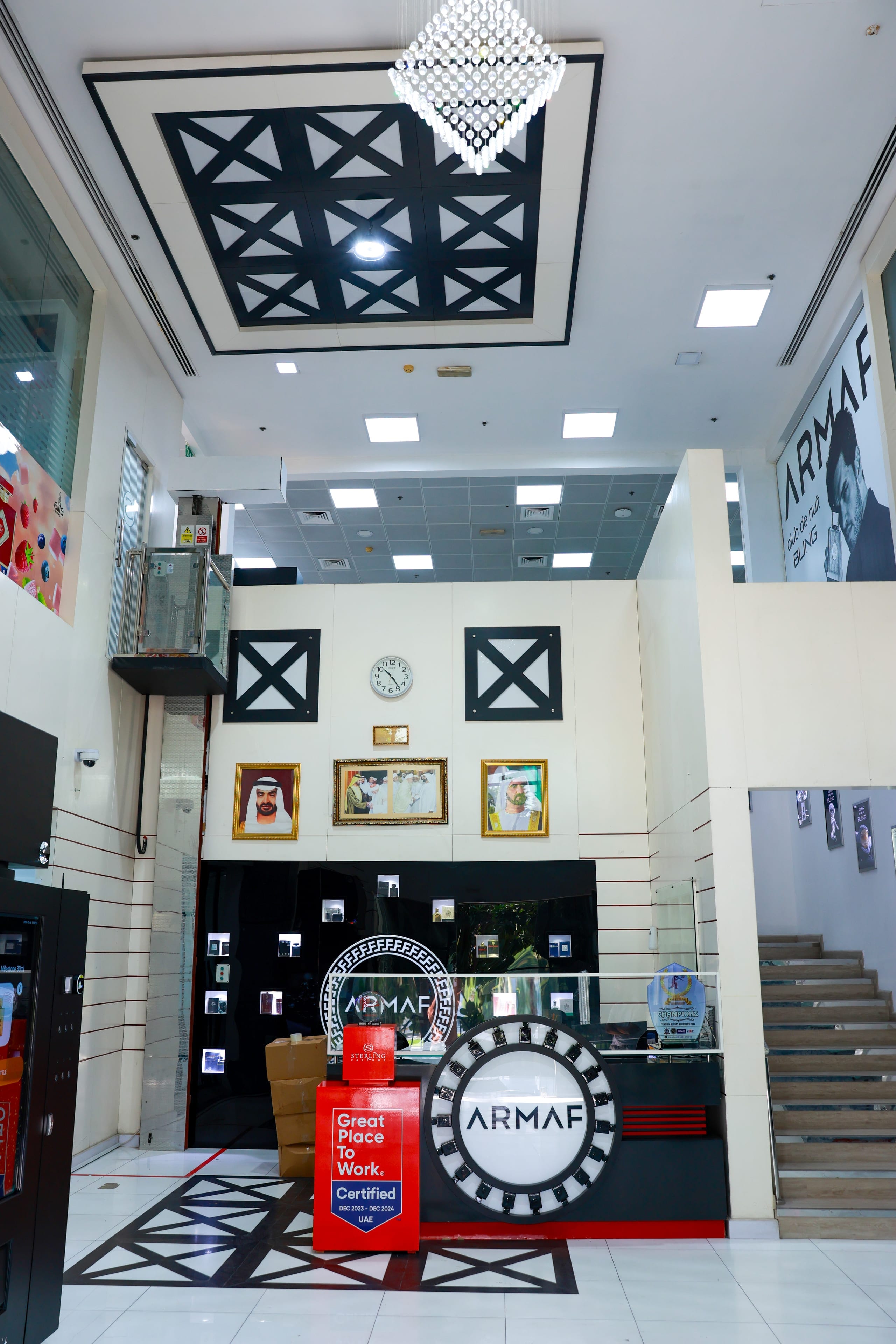 A double-height entrance lobby with a coffered ceiling and feature stair